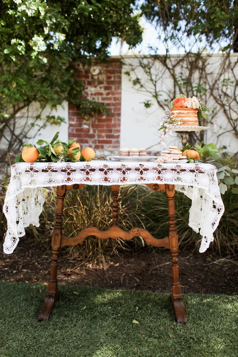 Wedding dessert table with naked wedding cake and oranges