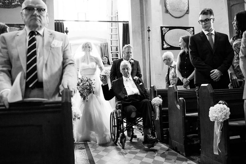 Father in wheelchair walking bride down the aisle