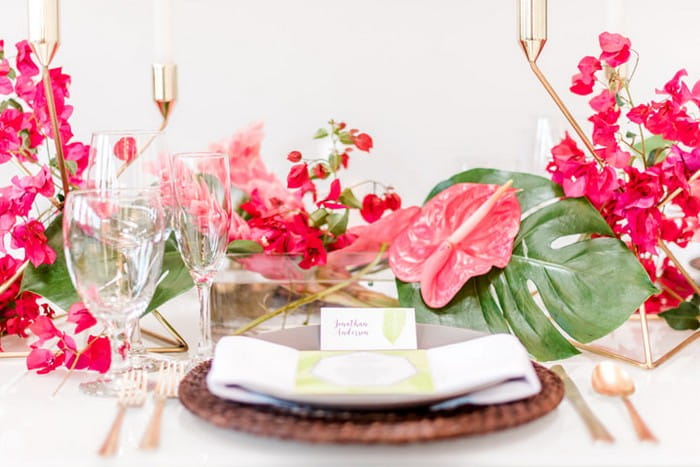 Wedding place setting with bright pink tropical wedding styling