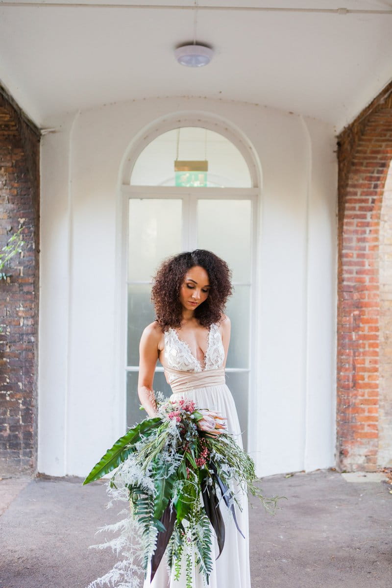 Bride holding oversized tropical bouquet