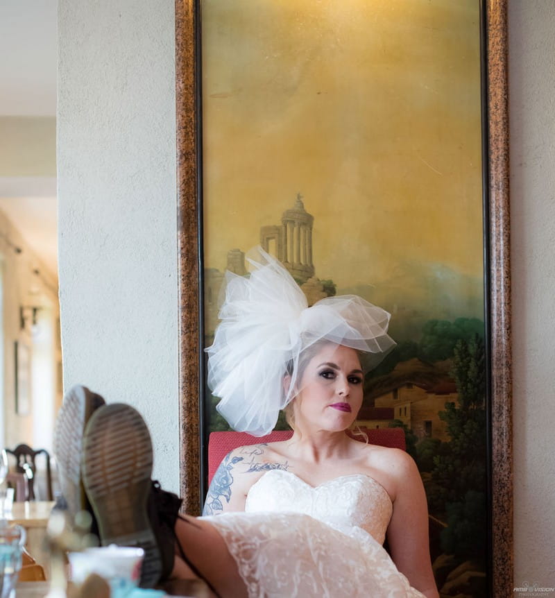 Bride sitting with feet up on table