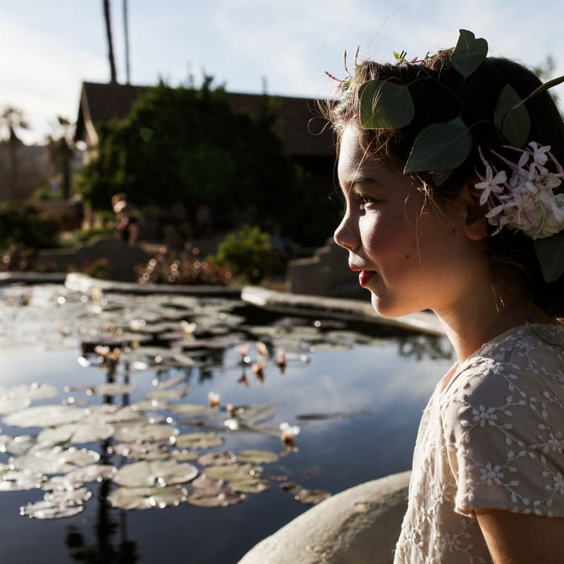 Flower girl looking at pond