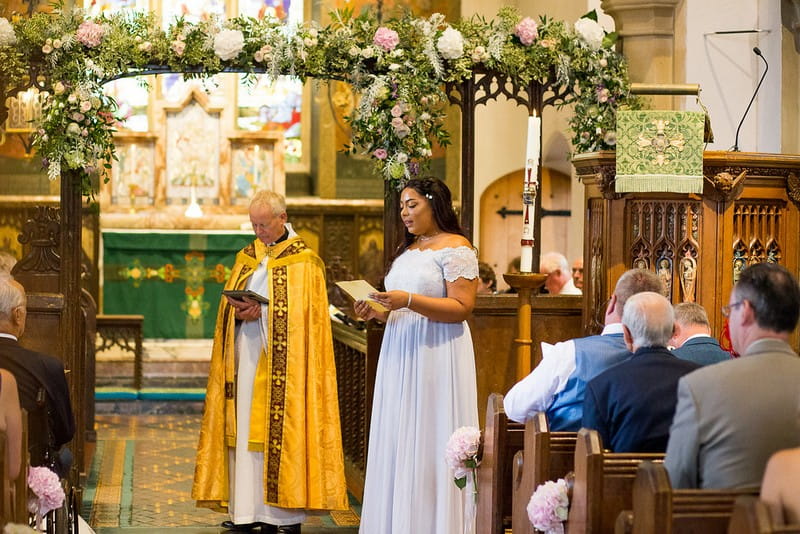 Bridesmaid giving reading during wedding ceremony