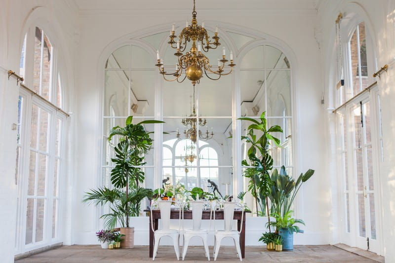 Wedding table with palm leaf and gold styling in Holland Park Orangery