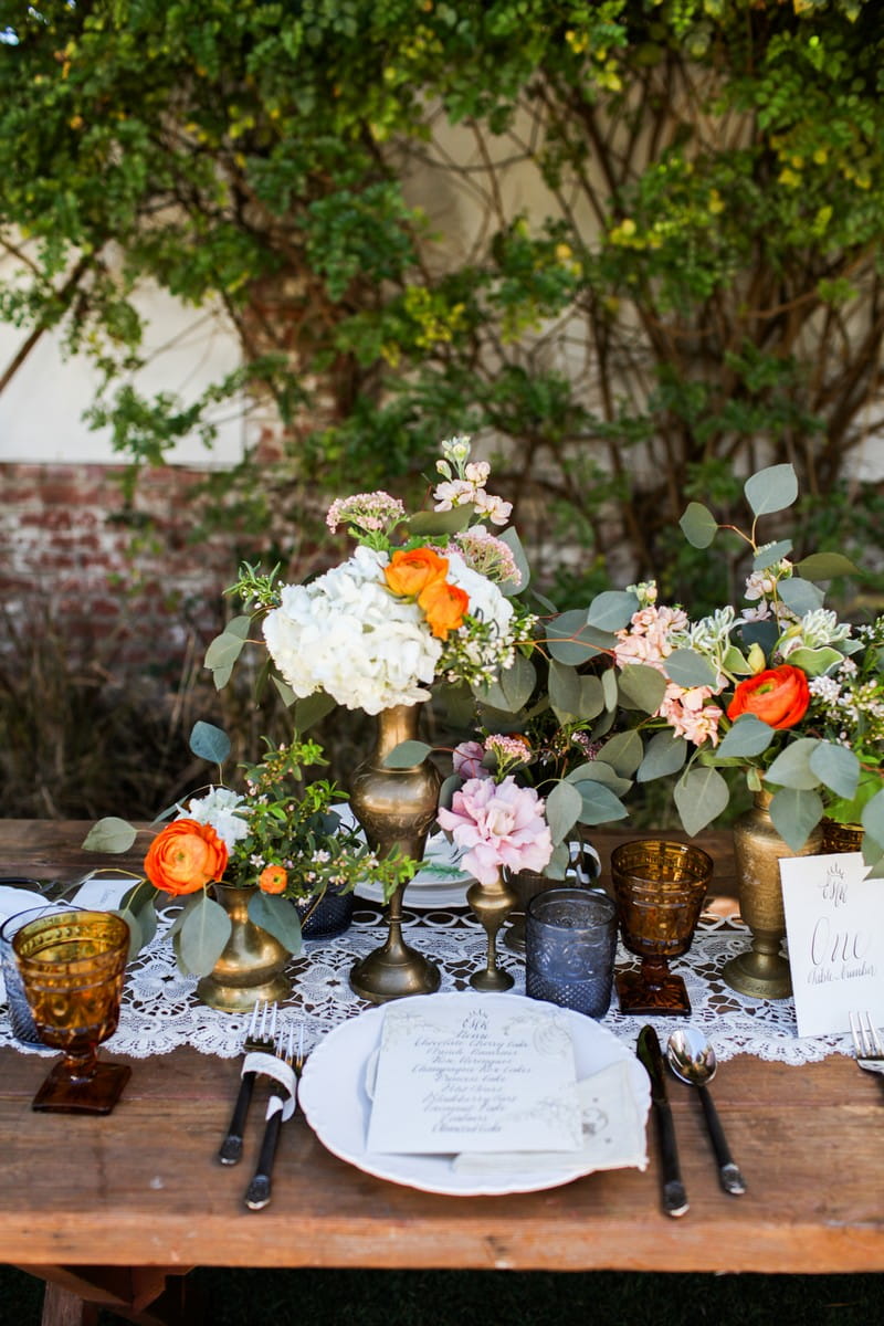 Rustic wedding place setting with orange and white flowers