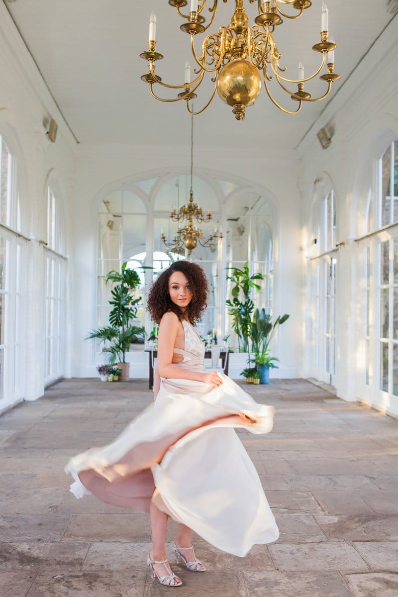 Bride twirling in dress in Holland Park Orangery