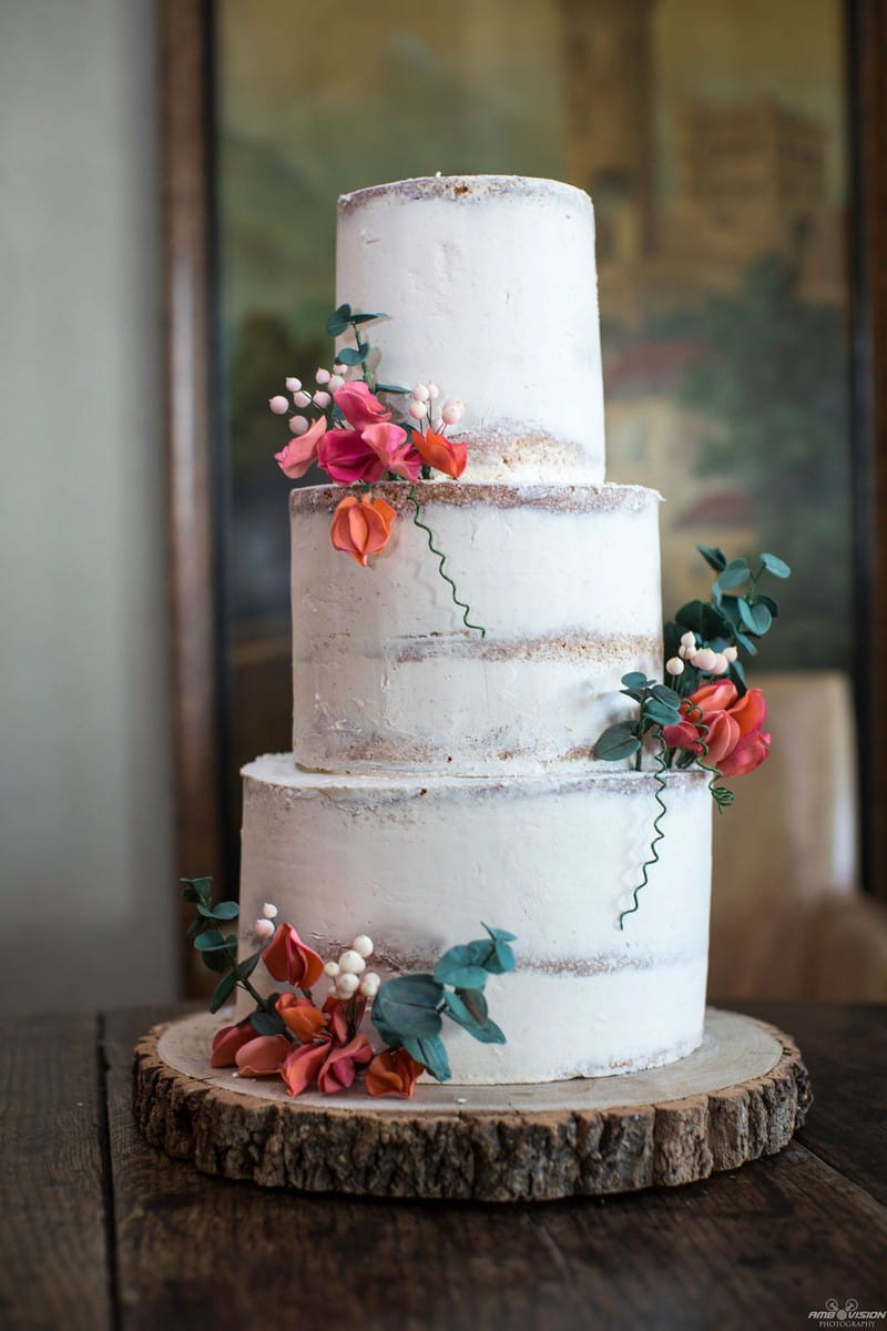 Simple white wedding cake with orange flowers