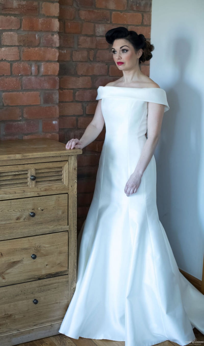 Bride standing next to chest of drawers
