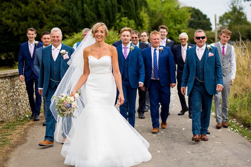 Bride with groomsmen in blue suits