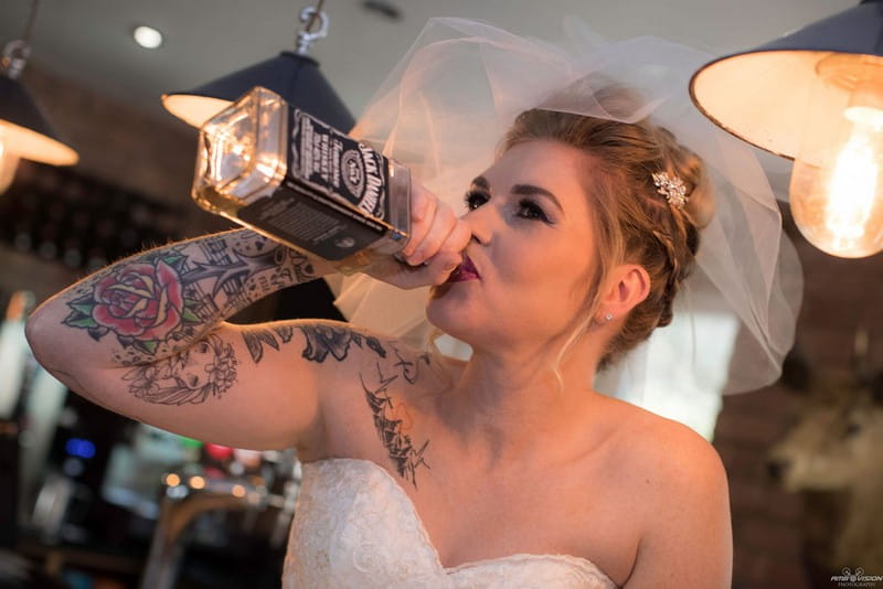 Bride drinking from Jack Daniel's bottle