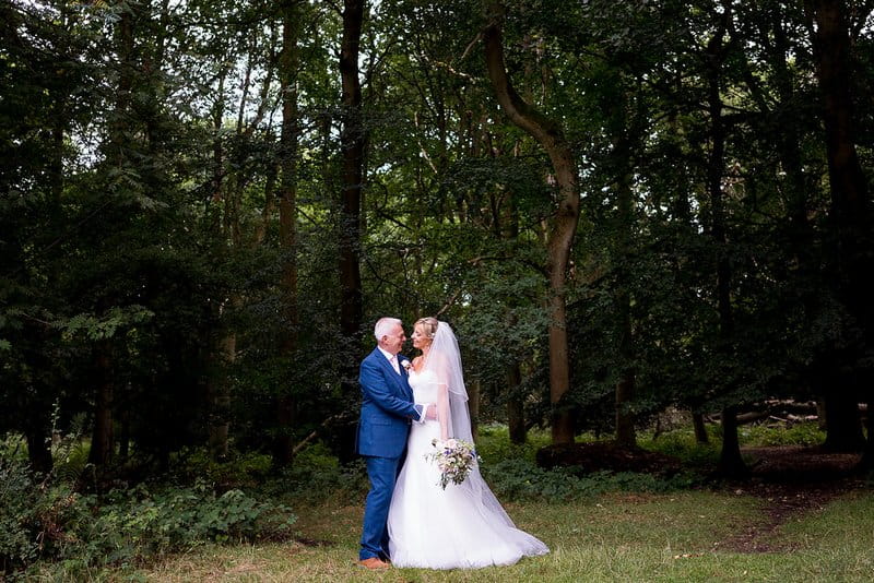 Bride and groom in woodland at Pendley Manor