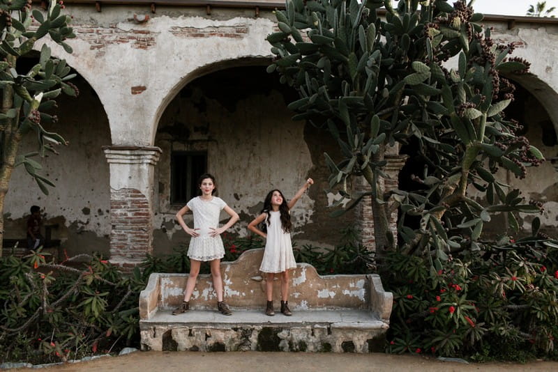 Flower girls standing on bench