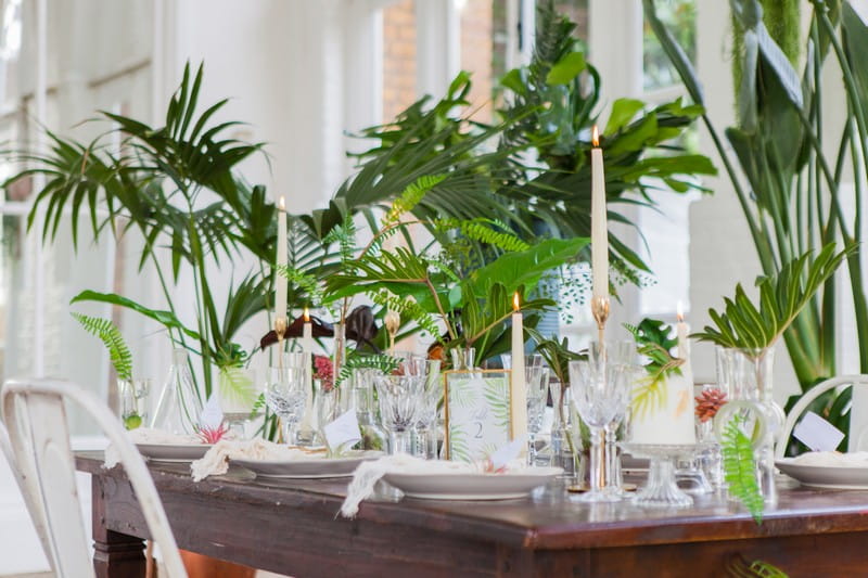 Wedding table styled with tropical palm leaves