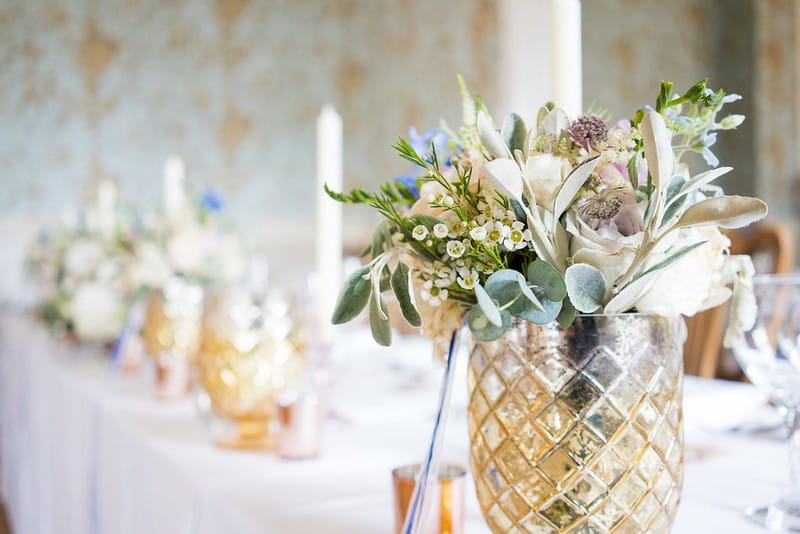 Gold glass vase of garden wedding flowers