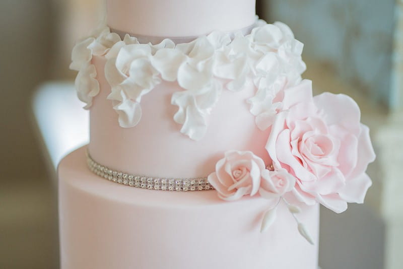 Sugar flowers and ruffles on pink wedding cake