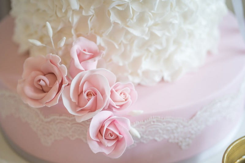 Pink sugar flowers on wedding cake