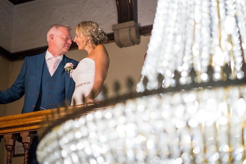 Bride and groom on gallery at Pendley Manor