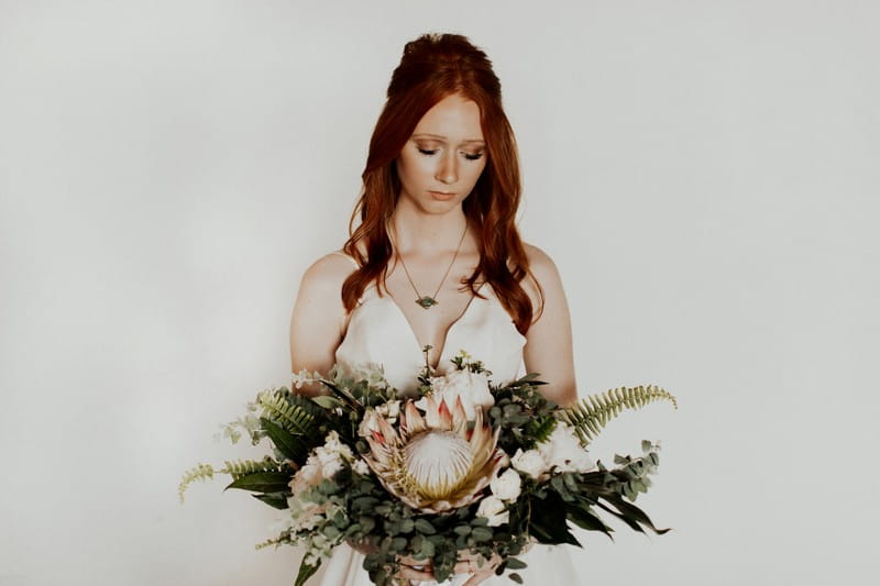 Bride holding bouquet with large flower
