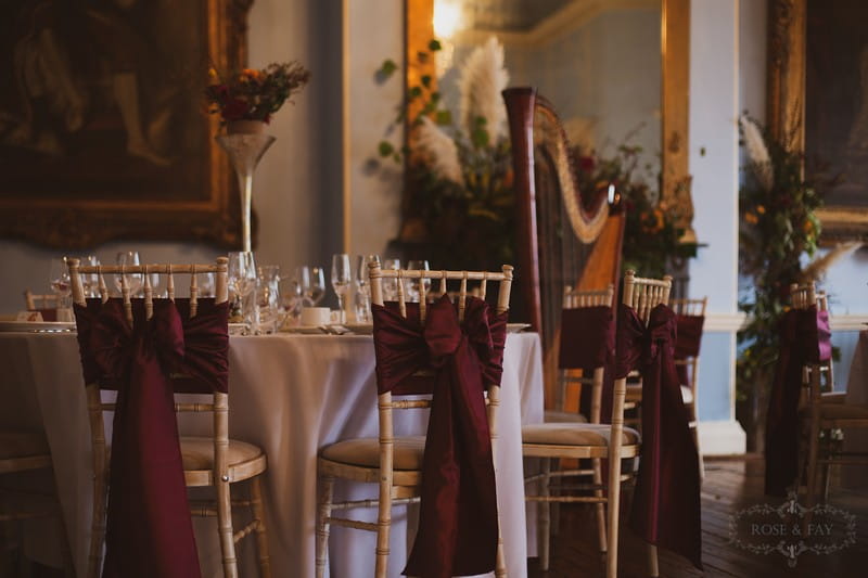 Burgundy sashes on wedding chairs