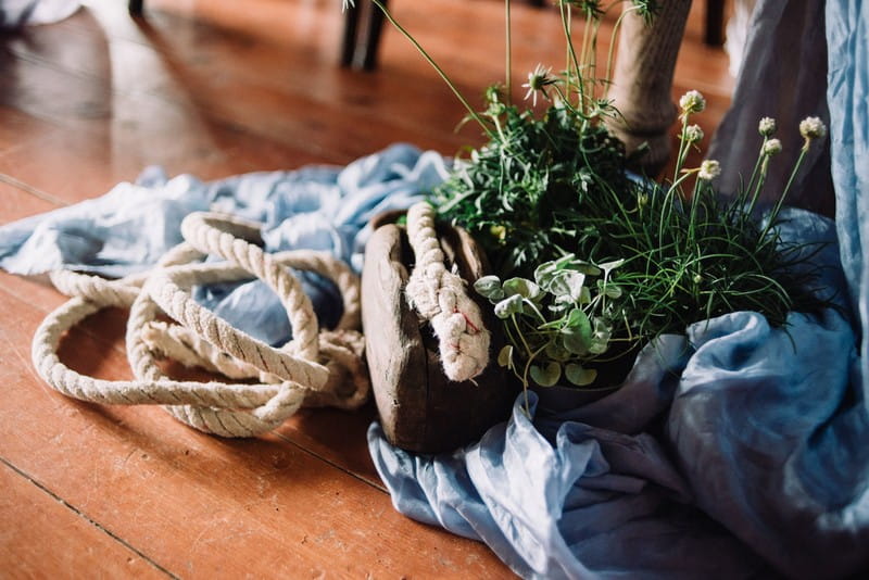 Rope and plant on top of blue linen on floor