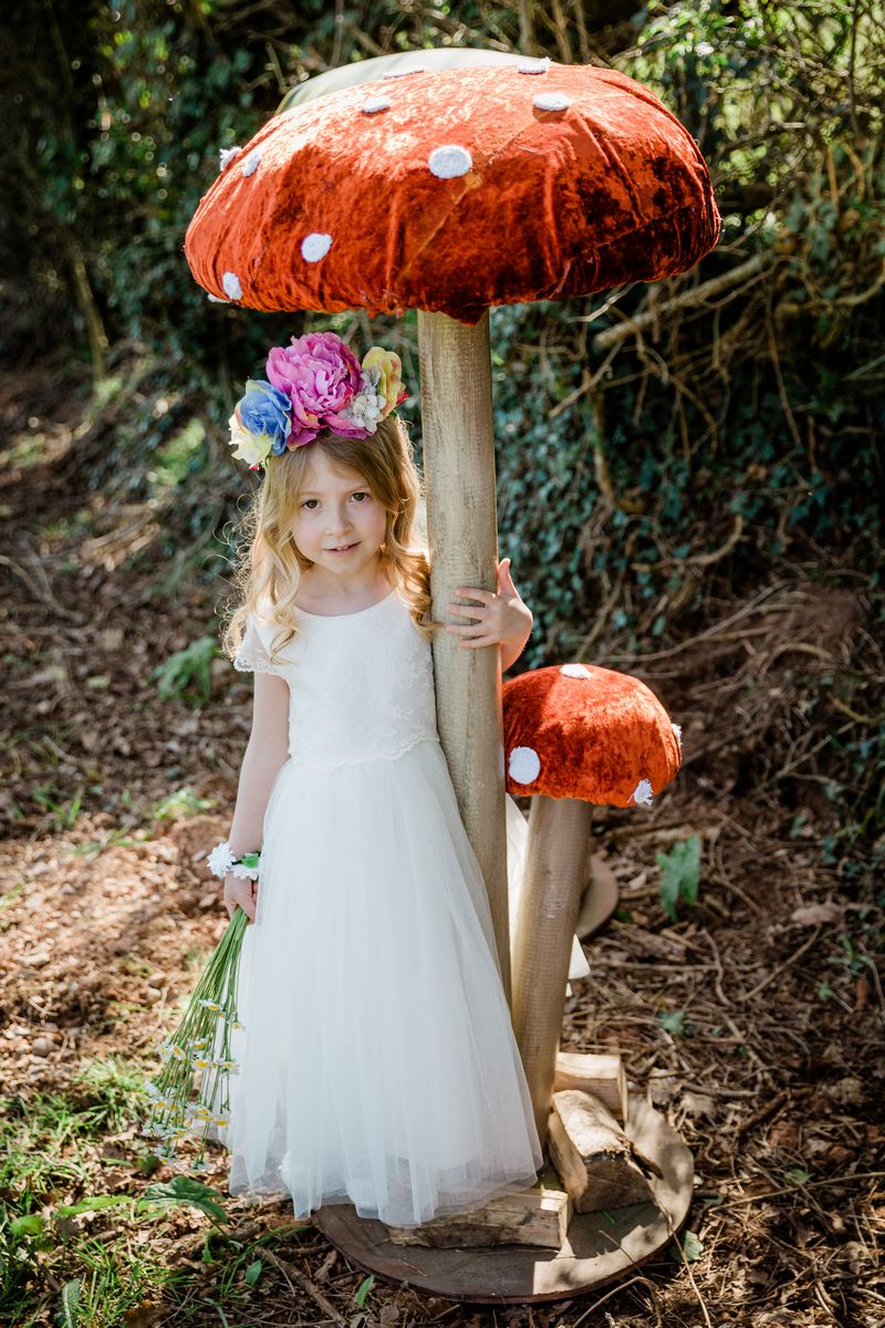 Flower girl standing under Giant Toadstool from The Prop Factory