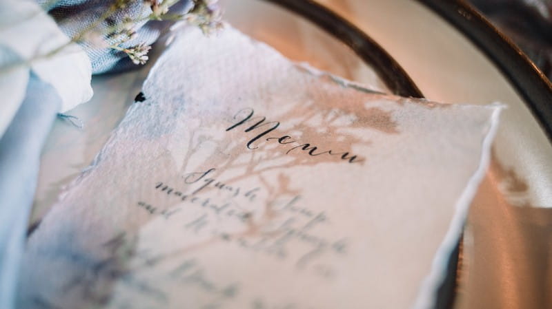 Wedding menu written on rustic paper