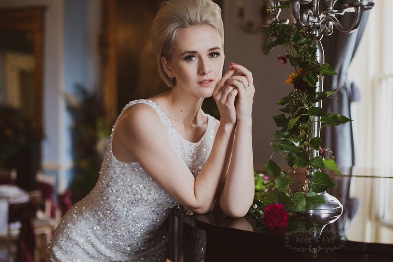 Bride leaning on piano