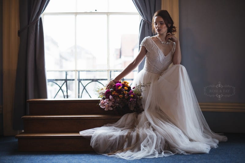 Bride sitting by window of Assembly Room in Devizes Town Hall