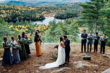 Outdoor wedding ceremony overlooking incredible view of trees, lakes and mountains - Picture by Marianne Chua Photography