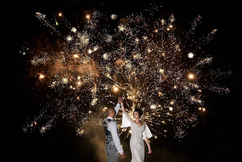 Bride and groom dancing in front of fireworks - Picture by Faye Amare Photography