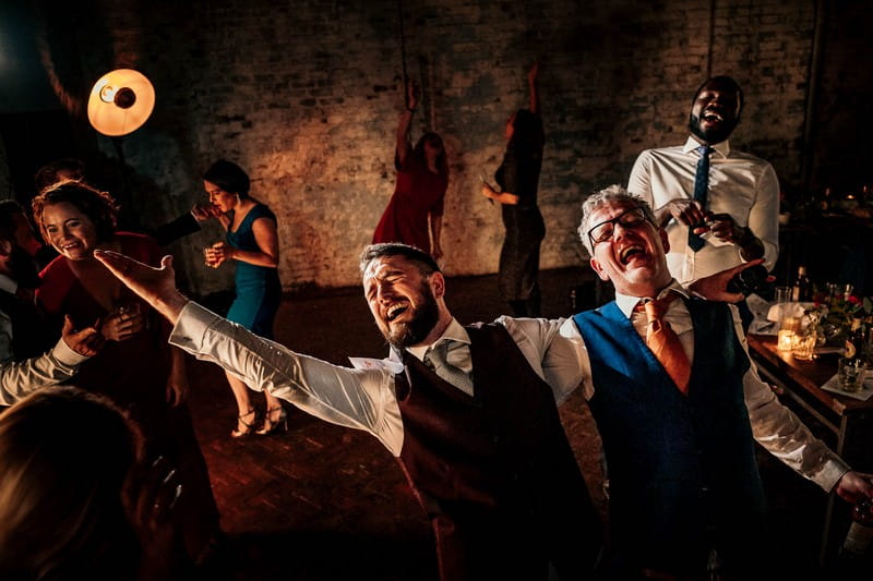 Two men singing enthusiastically at a wedding - Picture by Andrew Billington Photography