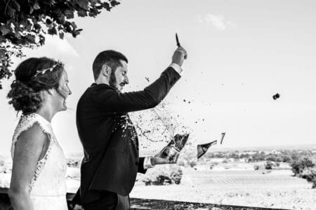 Bottle breaking as groom opens Champagne with a knife - Picture by Alison Bounce Photography