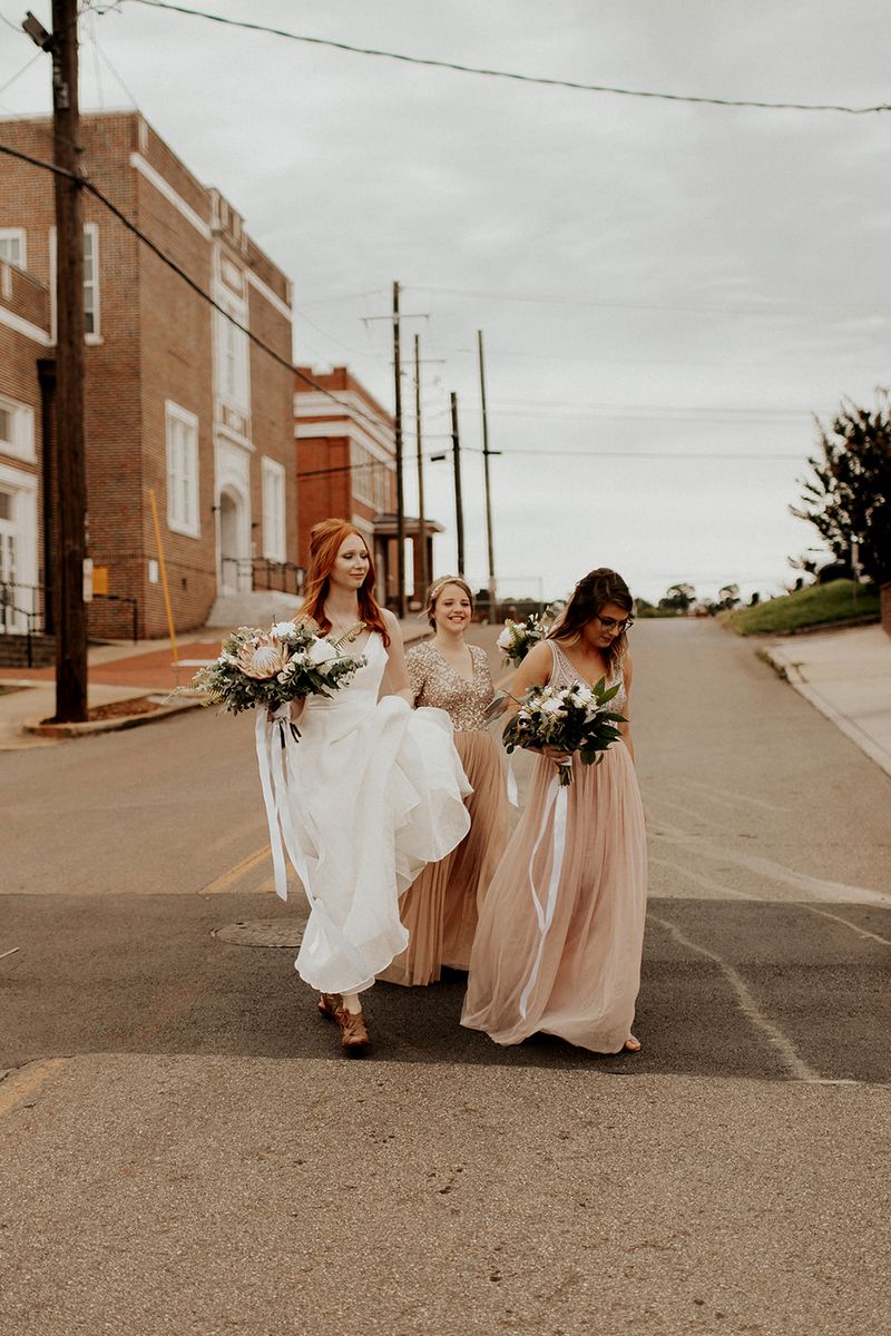 Bride walking across road with bridesmaids