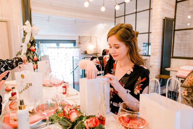 Bride-to-be taking gifts from bag at bridal shower
