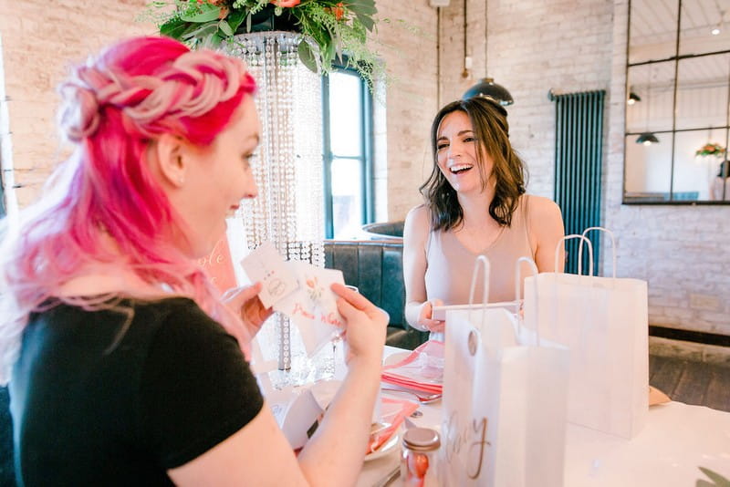 Girl with pink hair surprised at bridal shower gift