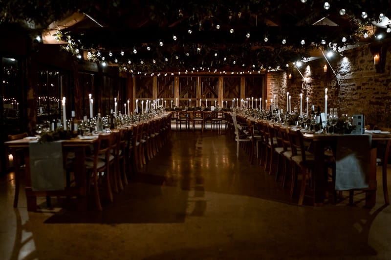 Long rustic wedding tables in The Wainhouse at Dewsall Court