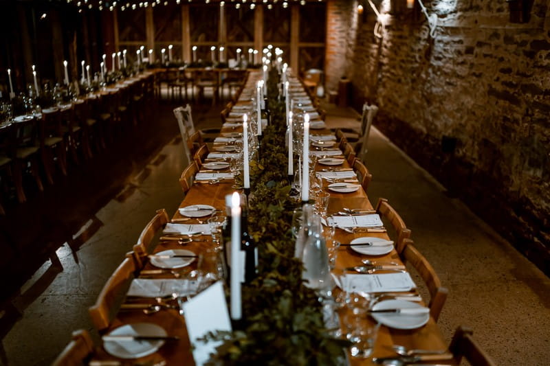 Long wedding table with rustic styling in The Wainhouse at Dewsall Court