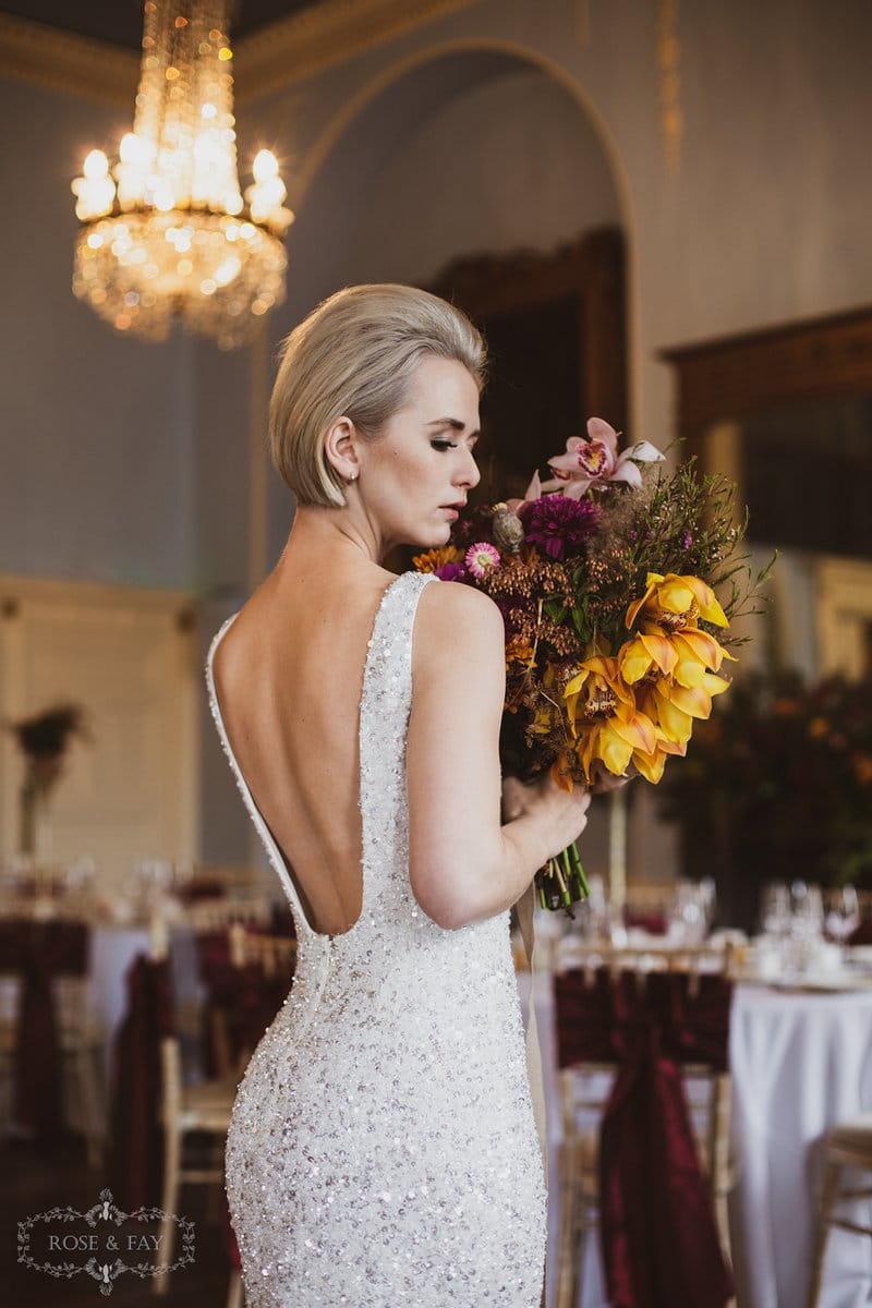 Bride holding autumnal bouquet