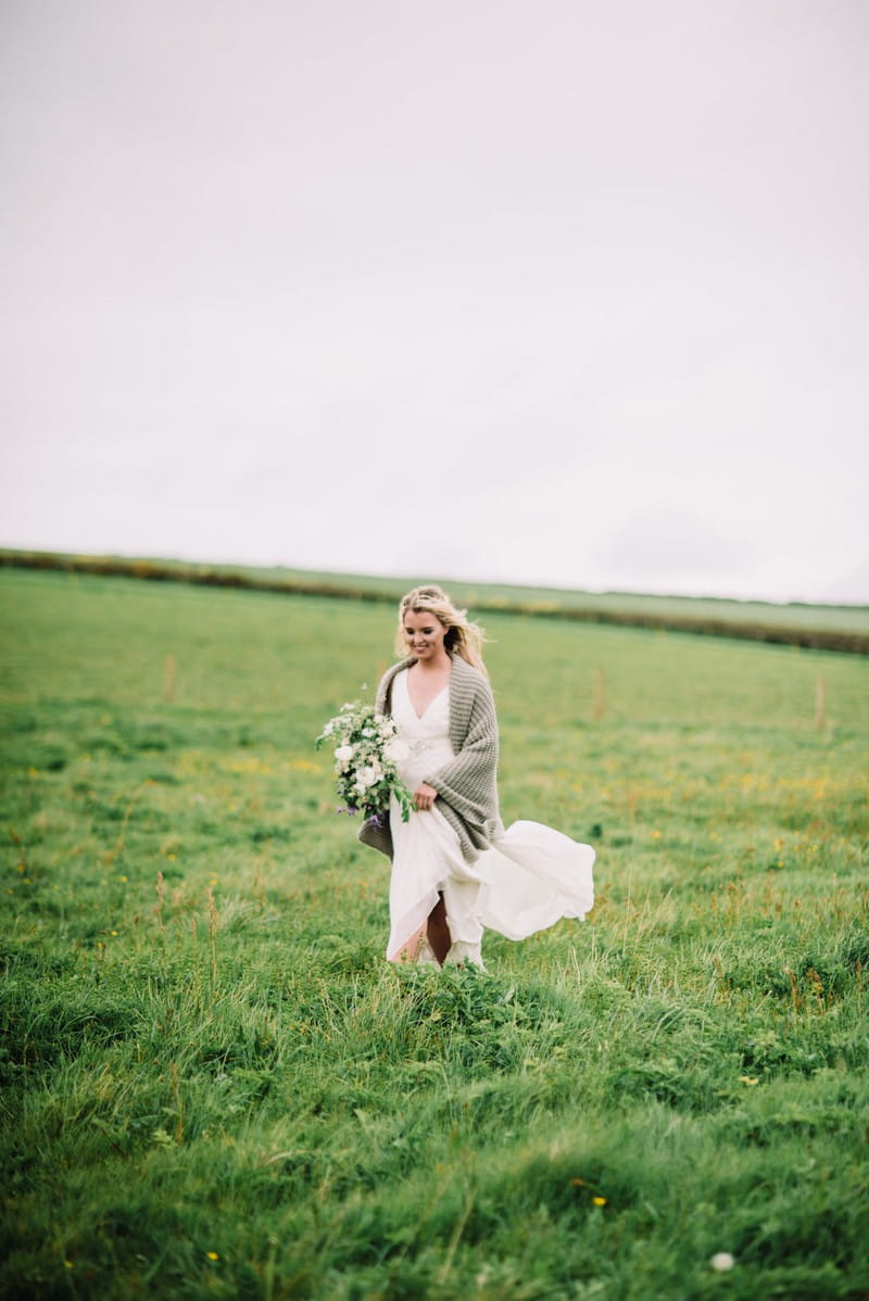 Bride walking across field
