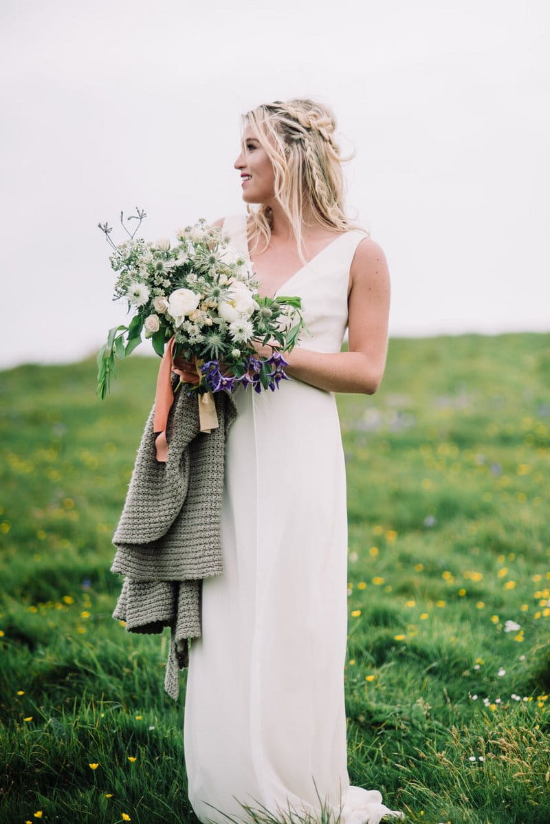 Bride holding bouquet and shawl
