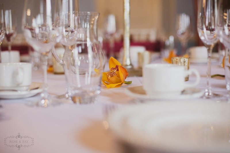 Orange/yellow flower on wedding table