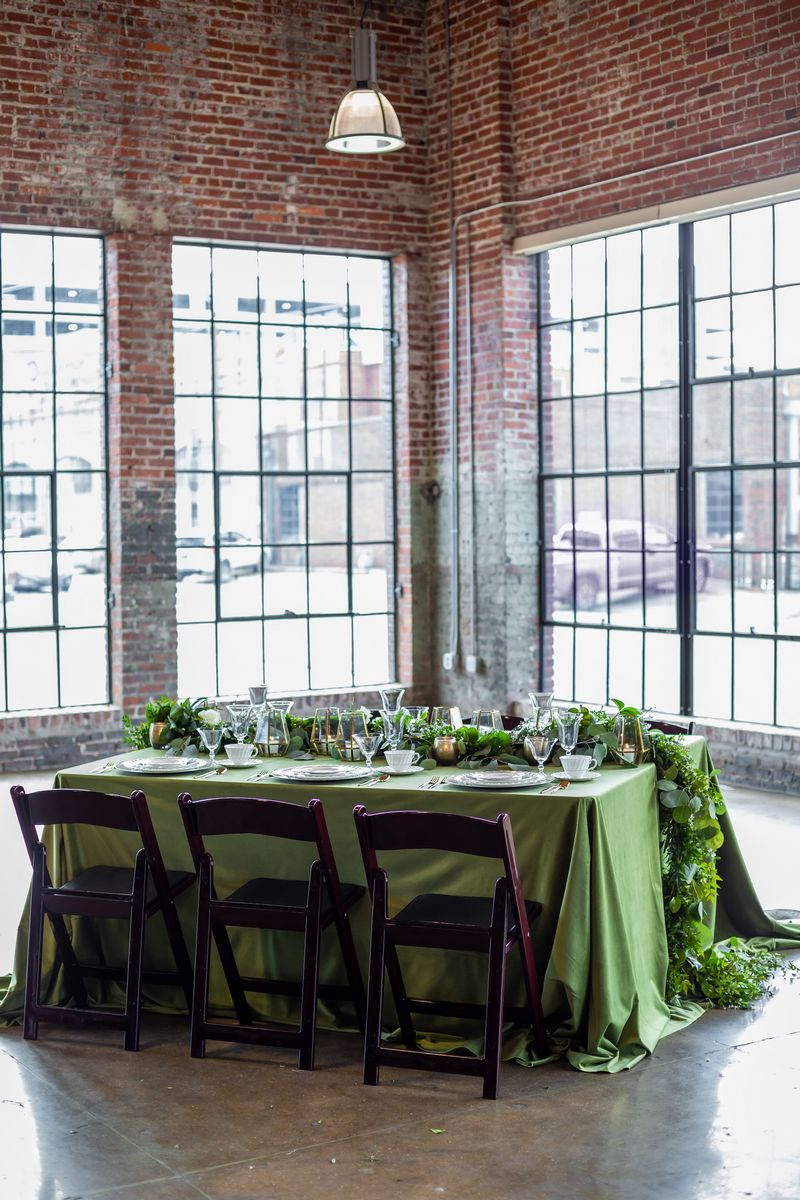 Wedding table with green tablecloth