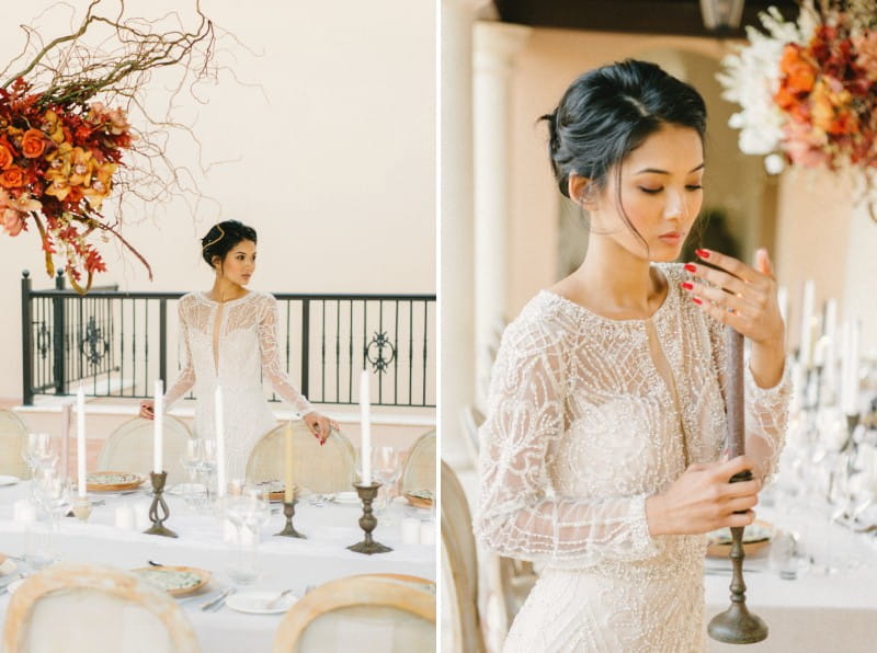 Bride holding candle next to wedding table