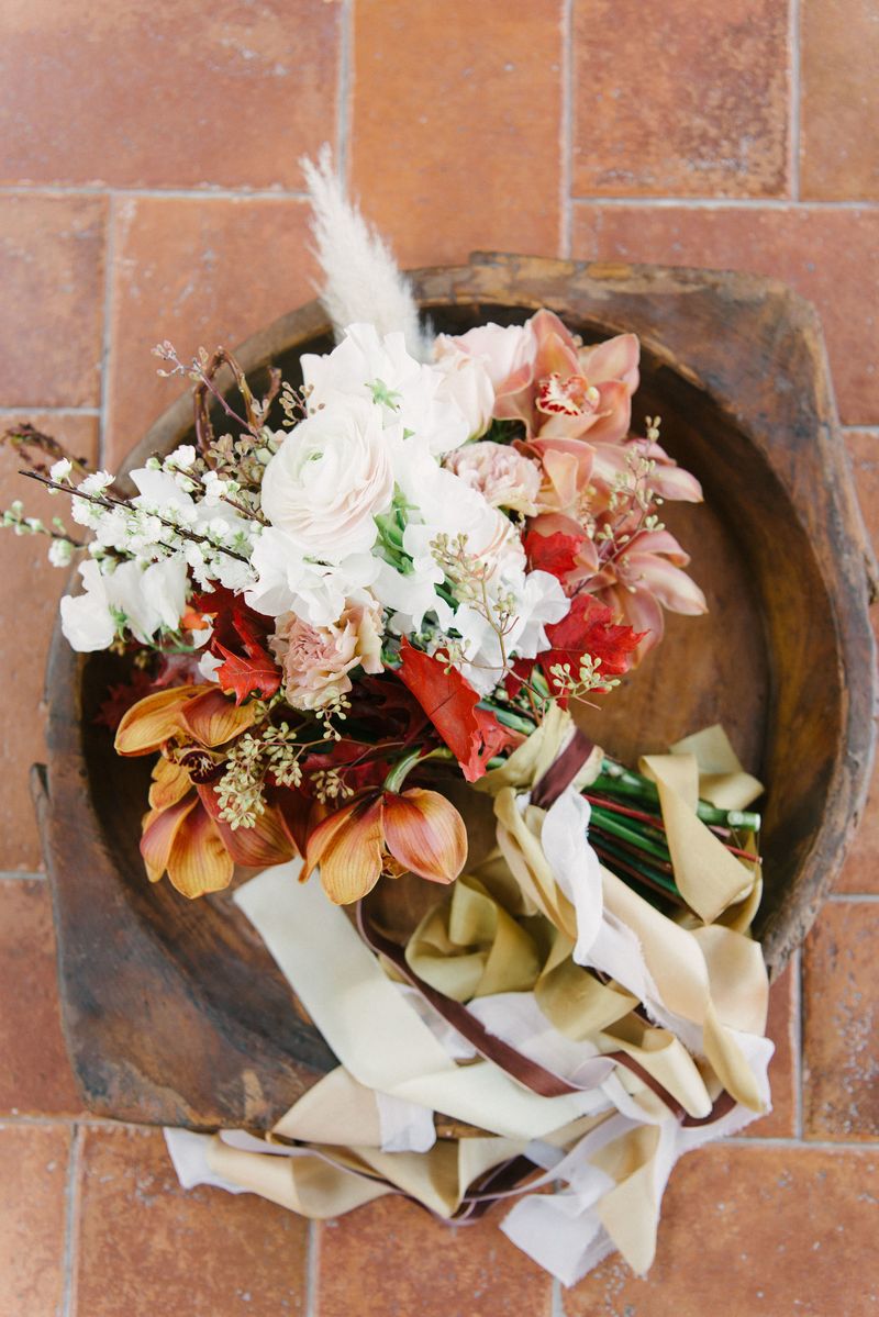 Autumnal wedding bouquet in wooden bowl