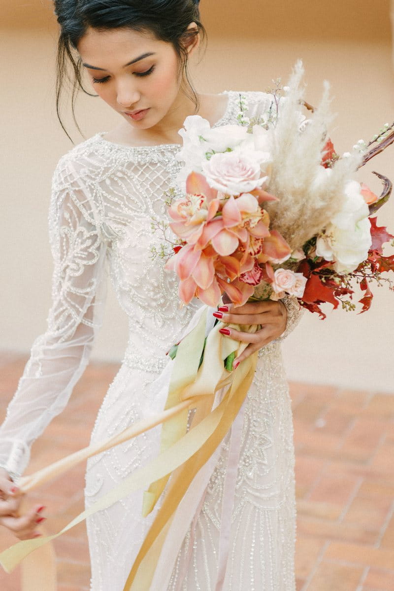 Bride holding elegant, autumnal wedding bouquet