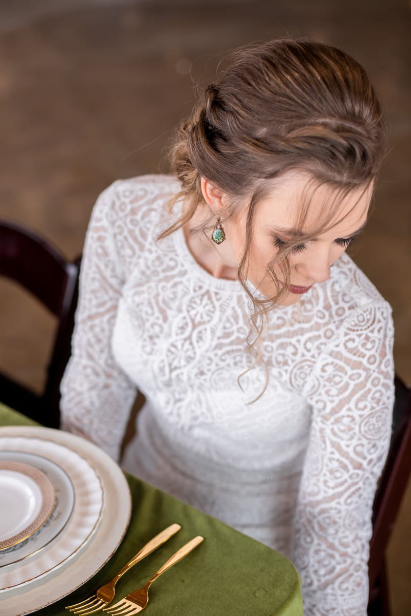 Bride with updo hairstyle sitting at wedding table