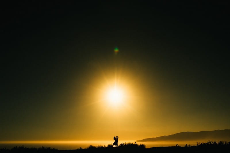 Silhouette of couple hugging under sun - Picture by Clarkie Photography