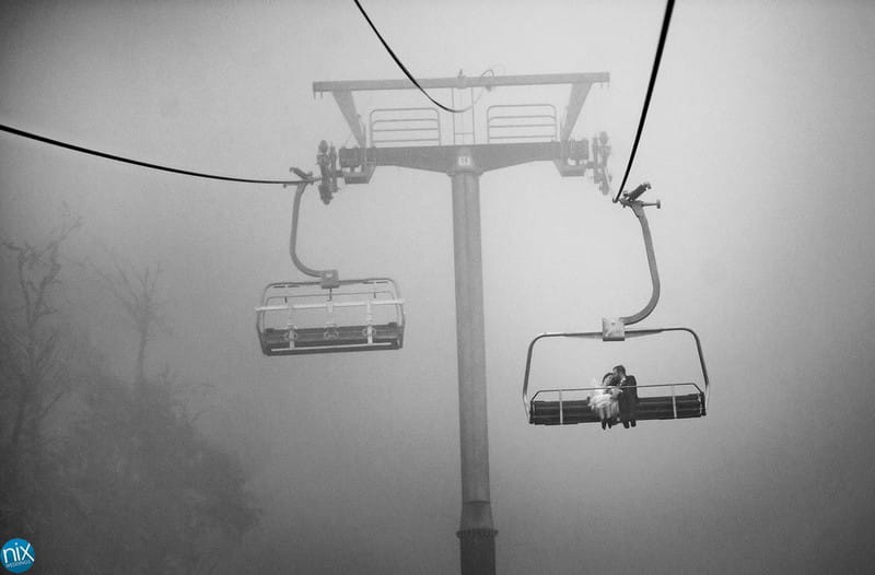 Bride and groom on ski lift - Picture by Nix Weddings
