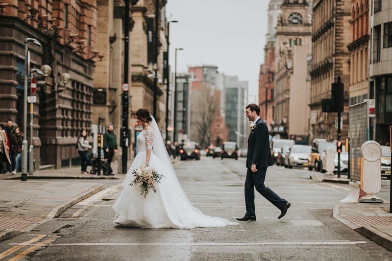 Bride and groom crossing the road in city - Picture by Sarah Maria Photography