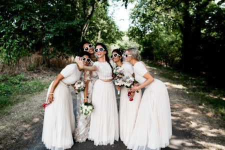 Bridesmaids in white dresses and heart sunglasses taking a selfie - Picture by Nicola Norton Photography